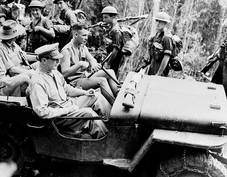 HistPOM-21-1942.jpg - Nov. 3, 1942: Pushing through New Guinea jungles in a jeep, General Douglas MacArthur inspects the positions and movements of United Nations Forces, who would push the Japanese away from Port Moresby and back over the Owen Stanley Mountain range. (AP Photo)
