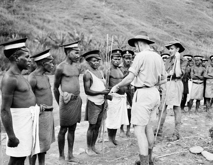 HistPOM-24-1948.jpg - Australian patrol officers pay wages to medical tultuls (officers) and luluais (village officials), Papua New Guinea, 1948. Medical tultuls wear caps with a white band and red cross. Pictured: David Cameron (right). Photographer: James (Jim) Fitzpatrick (source: Natioal Archives of Australia; http://www.naa.gov.au/collection/snapshots/on-patrol-in-papua-new-guinea/sogeri-barracks.aspx; accessed: 4.2.2013)